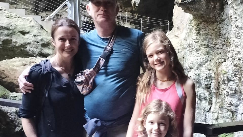Elly, Colin, Ayla, and Romy stop for a photo on the Cathedral Cave Tour at the Capricorn Caves.