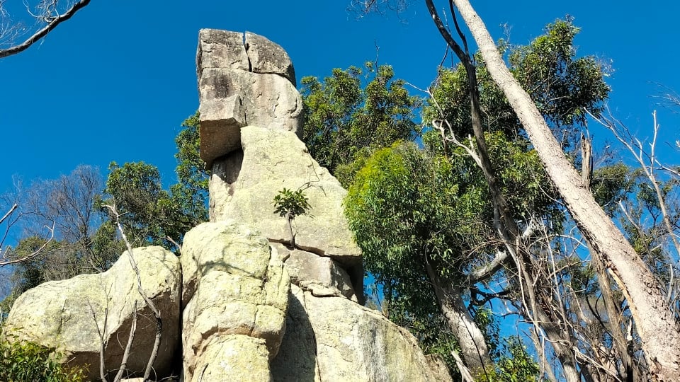 Fascinating rock formations on Magnetic Island against a backdrop of bright blue sky.
