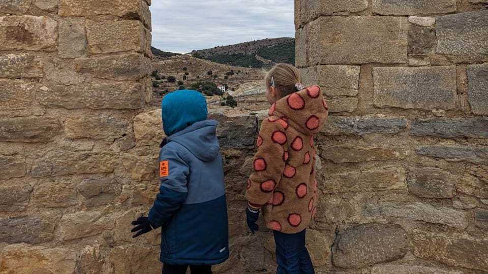 Two kids exploring one of Spain's historical sites.