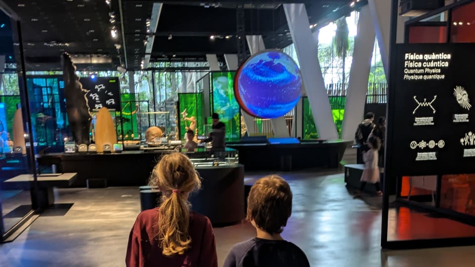 Two kids walk through one of Spain's family-friendly museums.