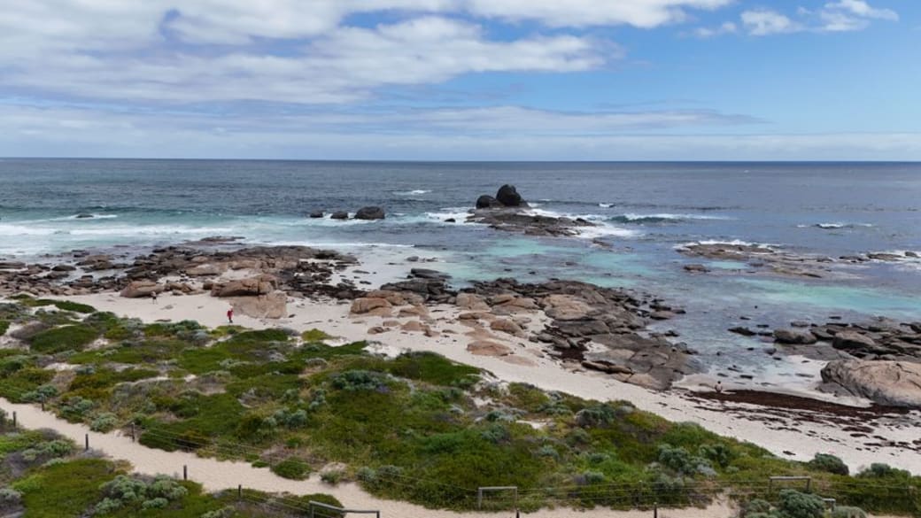 A breathtaking aerial view of Western Australia's rocky coastline and pristine blue waters.