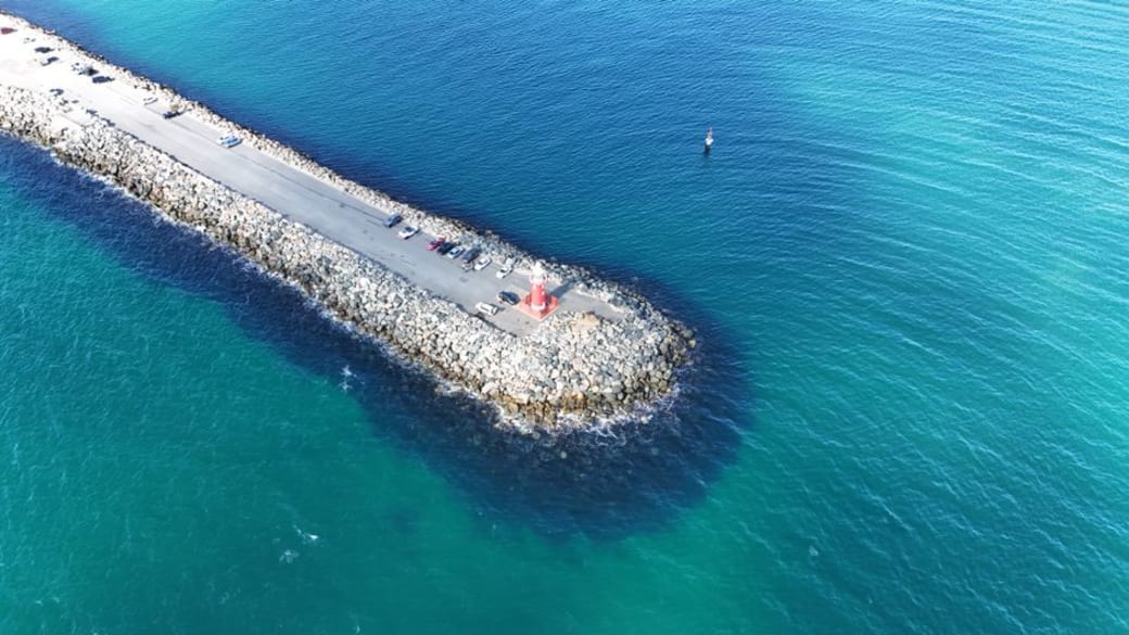 A captivating overhead shot of Fremantle’s Bather Beach jetty, surrounded by vibrant turquoise waters.