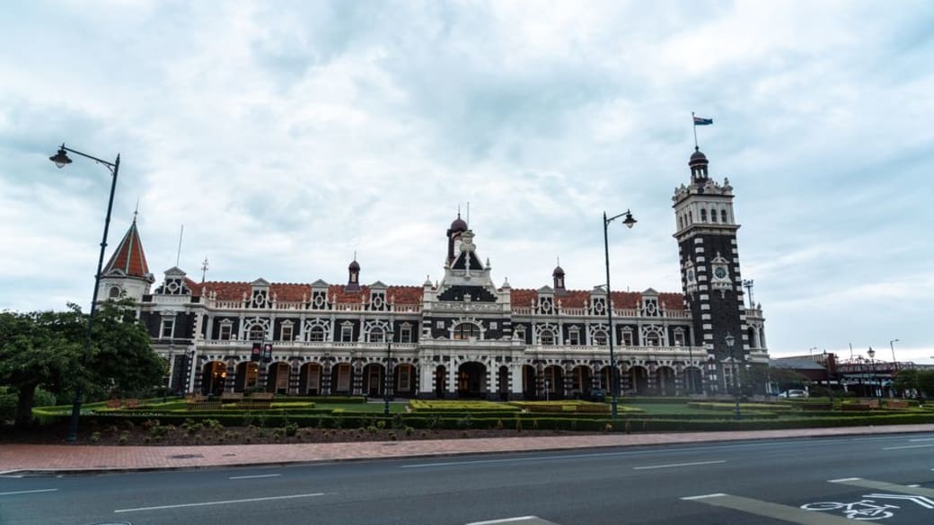 A captivating daytime shot showcasing the intricate historic architecture of Dunedin Railway Station.
