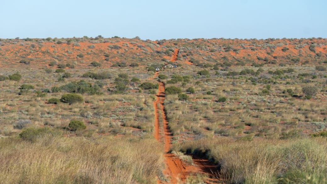 Remote desert road stretching through the iconic Australian outback, ideal for adventure exploration.