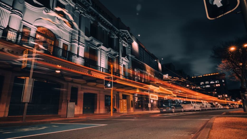 Vibrant city life in Wellington captured with stunning light trails on a bustling street at night.