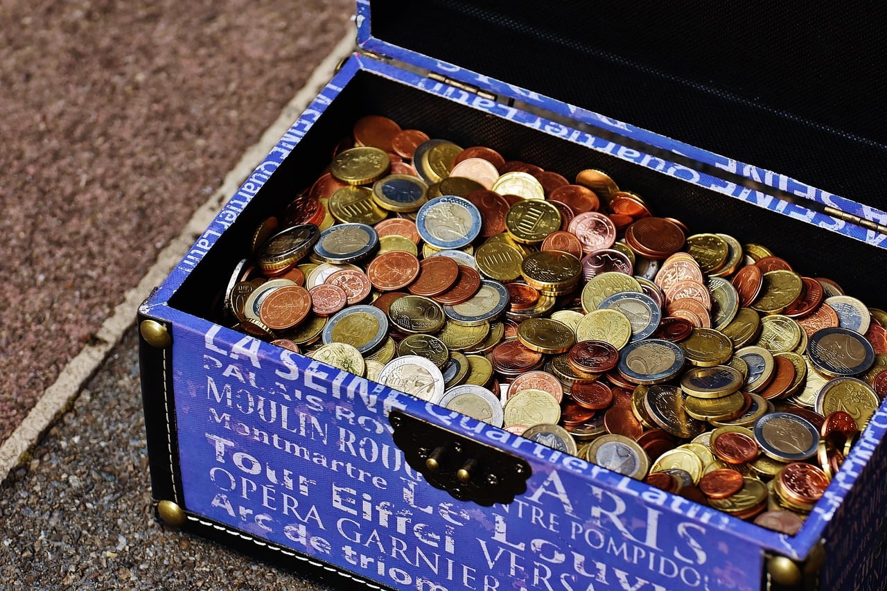 Old style suitcase/chest decorated with French terminology and filled with coins