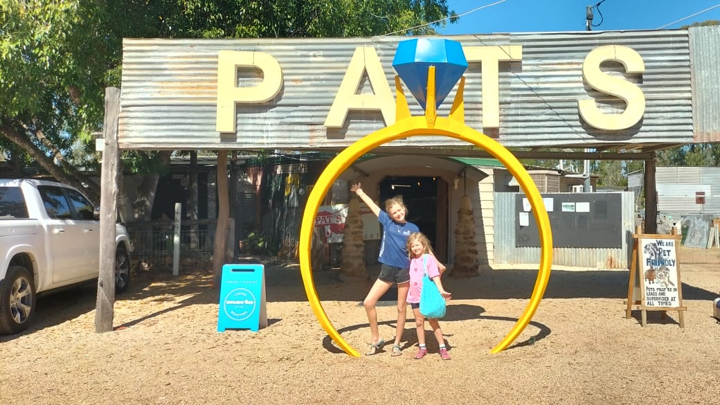 Ayla and Romy stop for a photo inside a giant sapphire ring at Pats Gems Tourist Fossicking Park and Cafe in Sapphire.