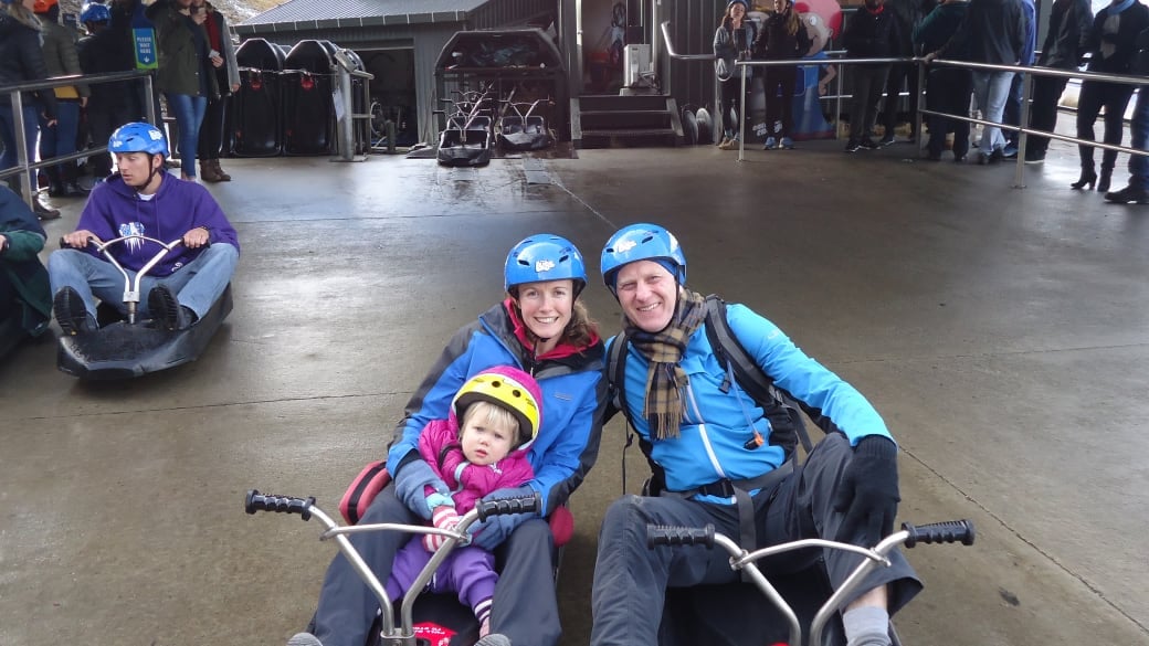 Elly, Ayla and Colin smile for a photo in their luge cars at the top of the Queenstown Luge.