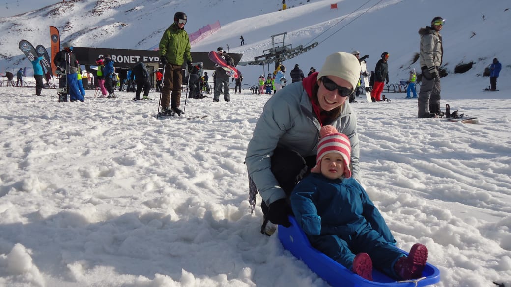 Little Ayla trying snow sledding with mum at Coronet Ski Field near Queenstown.