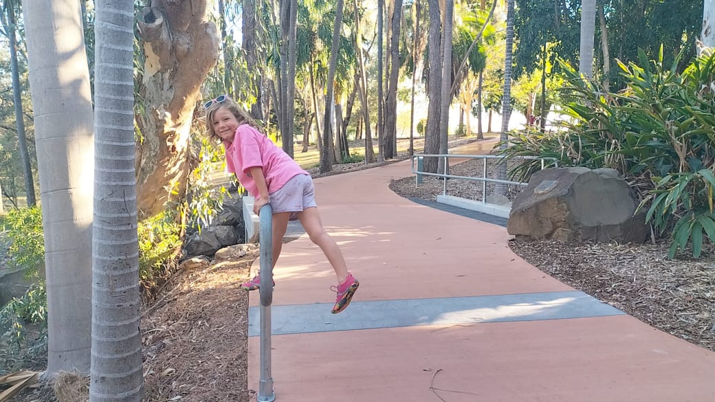 Romy climbing on a fence at the Emerald Botanic Gardens in the Central Queensland Highlands.