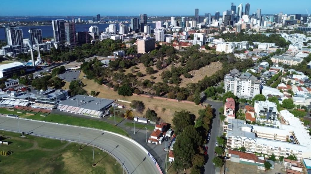 Stunning aerial shot showcasing Perth city skyline, parks, and river in sunny daylight.