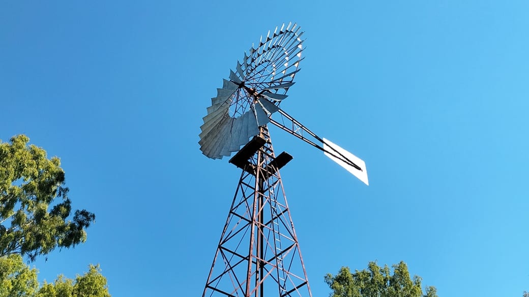 The windmill at the historic park in Springsure, Central Queensland Highlands, with a gorgeous bright blue sky above.