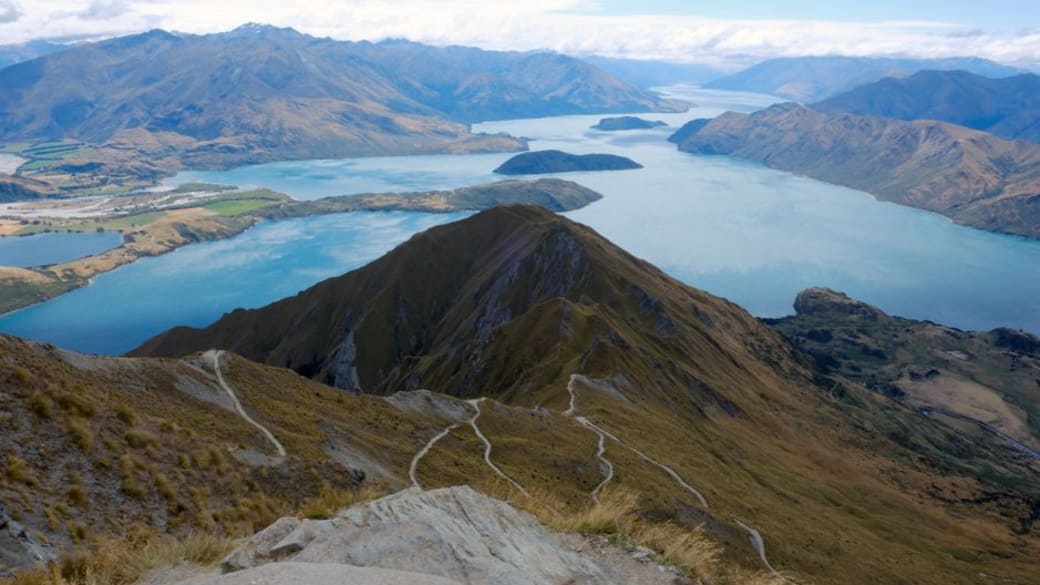 A breathtaking aerial view of Lake Wānaka and surrounding mountains from Roys Peak, New Zealand.