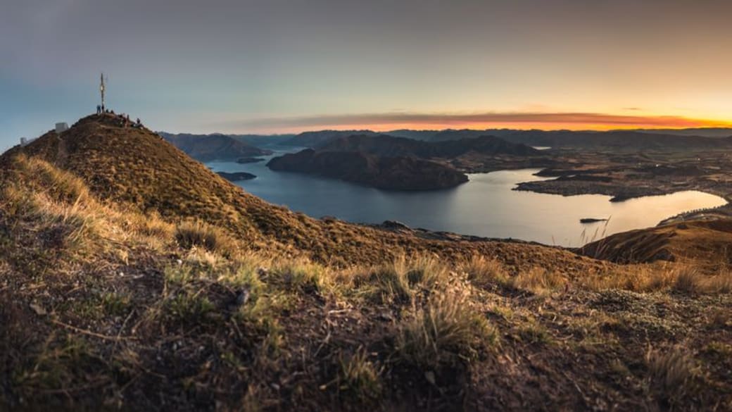 Beautiful panoramic view of Lake Wanaka from a hilltop at sunrise in New Zealand.