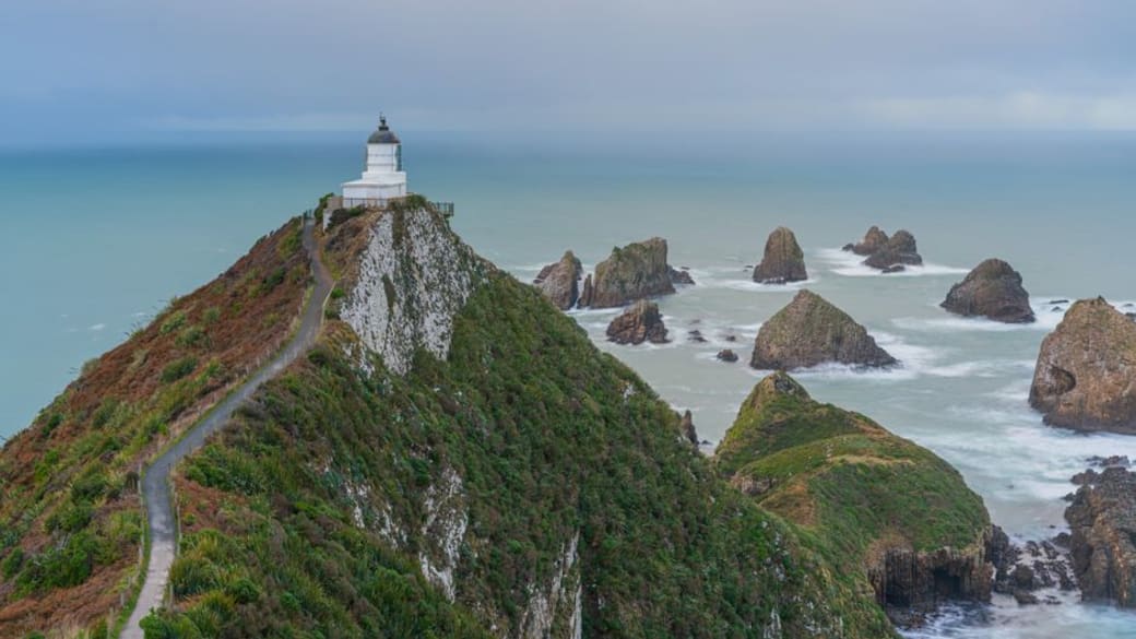 Breathtaking view of Nugget Point Lighthouse in the Catlins overlooking rugged coast in Otago.