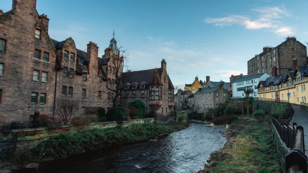 Charming view of historic buildings along the Water of Leith in Edinburgh's Dean Village.