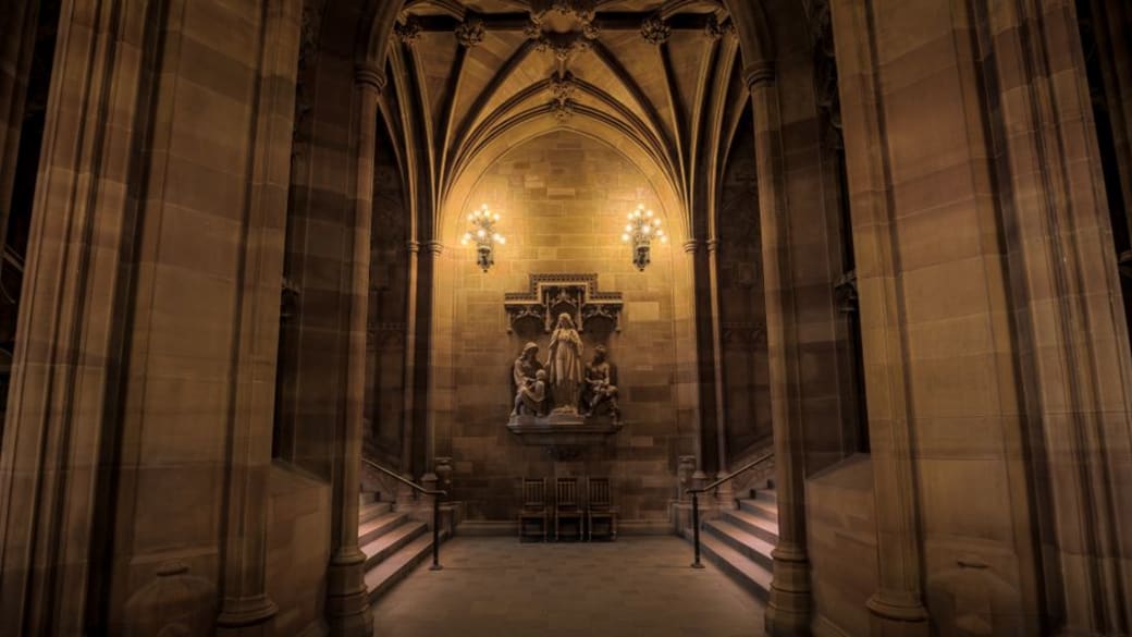 The historic Gothic interior of the John Rylands Library in Manchester.