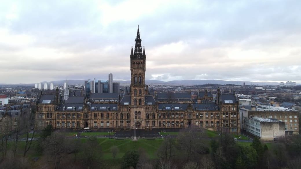 Aerial view of the University of Glasgow with surrounding architecture and skyline.