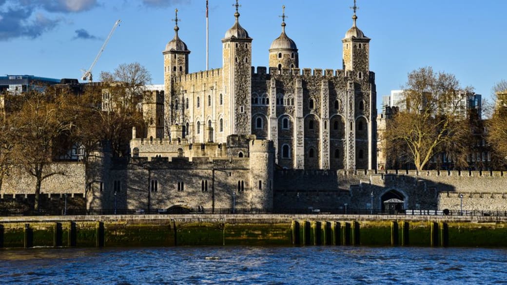 View across the Thames to the Tower of London with a clear blue sky