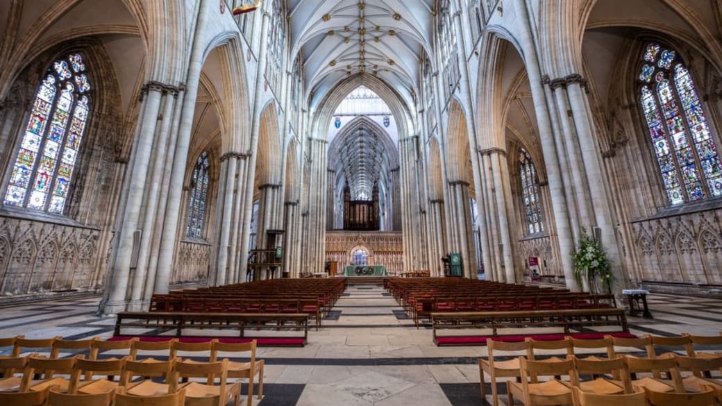 Stunning view of the gothic nave inside York Minster in England, showcasing its architectural grandeur.