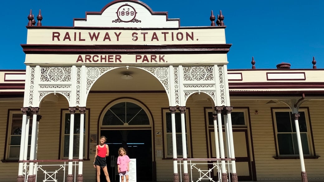 Ayla and Romy out the front of the Archer Park Rail Museum in Rockhampton on a bright blue sky day.