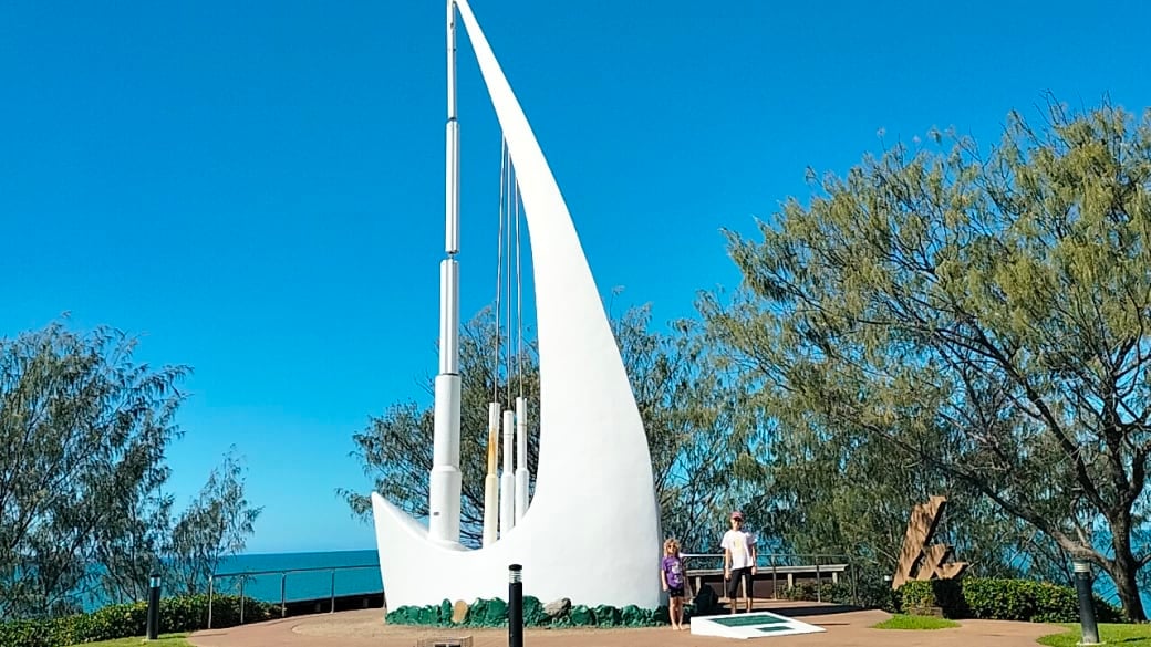 Ayla and Romy standing beside the Singing Ship at Emu Park on the Capricorn Coast on a stunning blue sky day.