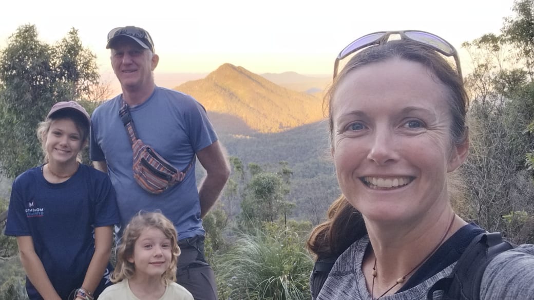 Elly, Colin, Ayla, and Romy stop for a family selfie on one of the hiking trails up Mount Archer in Rockhampton.